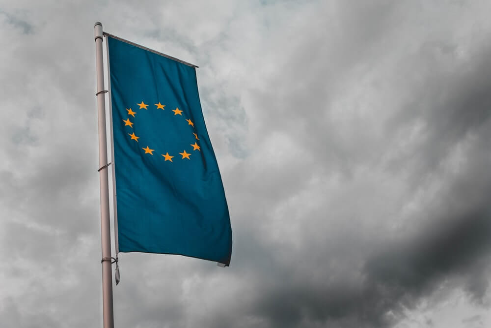 EU flag with cloudy sky